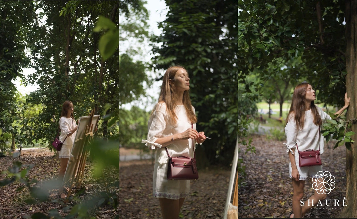 Woman painting in a leafy garden, calm and at ease, carrying the Nopal Luxe Pochette, a vegan cactus leather crossbody by Shaurè